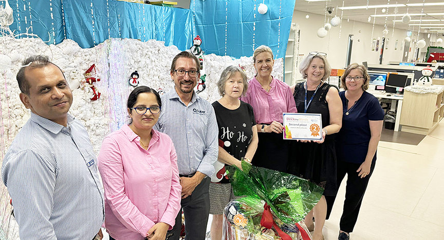 Staff in medical records at Gladstone Hospital receiving a 2nd place certificate for their Christmas decorations