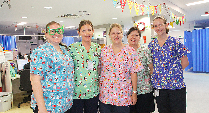 Four nurses wearing christmas theme scrubs at Rockhampton Hospital Emergency Department 