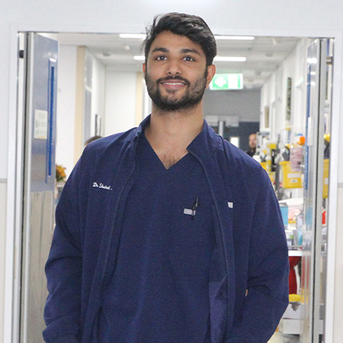 Doctor smiling at the camera, standing in a Rockhampton Hospital corridor.