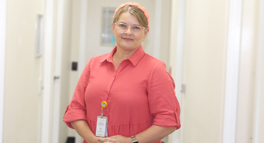 Clinical Nurse Kerry standing in a corridor and smiling at the camera 