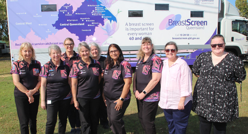 A group of BreastScreen Queensland team members stand in front of the new mobile screening unit.