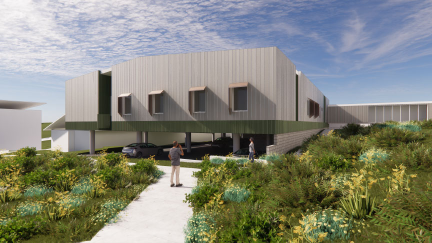 Computer-generated image of the new Mental Health Unit, showing a raised single-story white building with a car park underneath. Cars take up some of the parks. In front of the building people are seen walking along a footpath  surrounded by gardens.