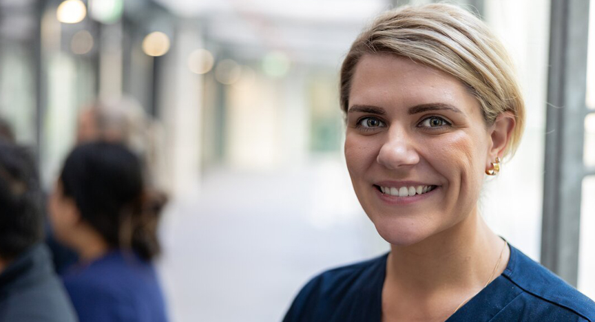 Nurse smiles at camera